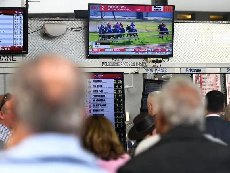 Racegoer place bets during the Doomben Cup Day