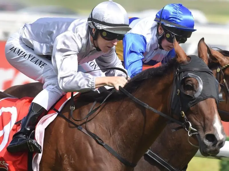 Jockey Damian Lane rides Bedford (L) to victory in Race 7,