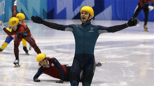 Not even Stephen Bradbury can believe it. He is pictured crossing the winning line with a path of destruction behind him.