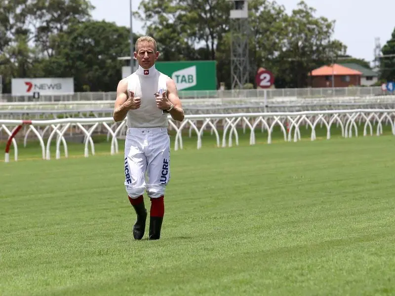 Jockeys including Dale Smith gave the new Eagle Farm track a general thumbs-up. Jockey Dale Smith inspects the turf at Eagle Farm