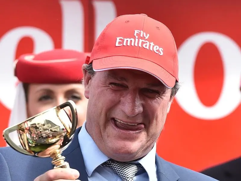 Police have raided the stables of leading trainer Darren Weir. Trainer Darren Weir celebrates winning the 2015 Melbourne Cup.