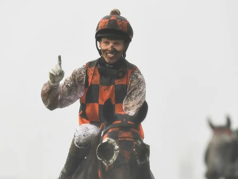 Jockey Corey Bayliss gestures after riding Madam Shazam to victory.