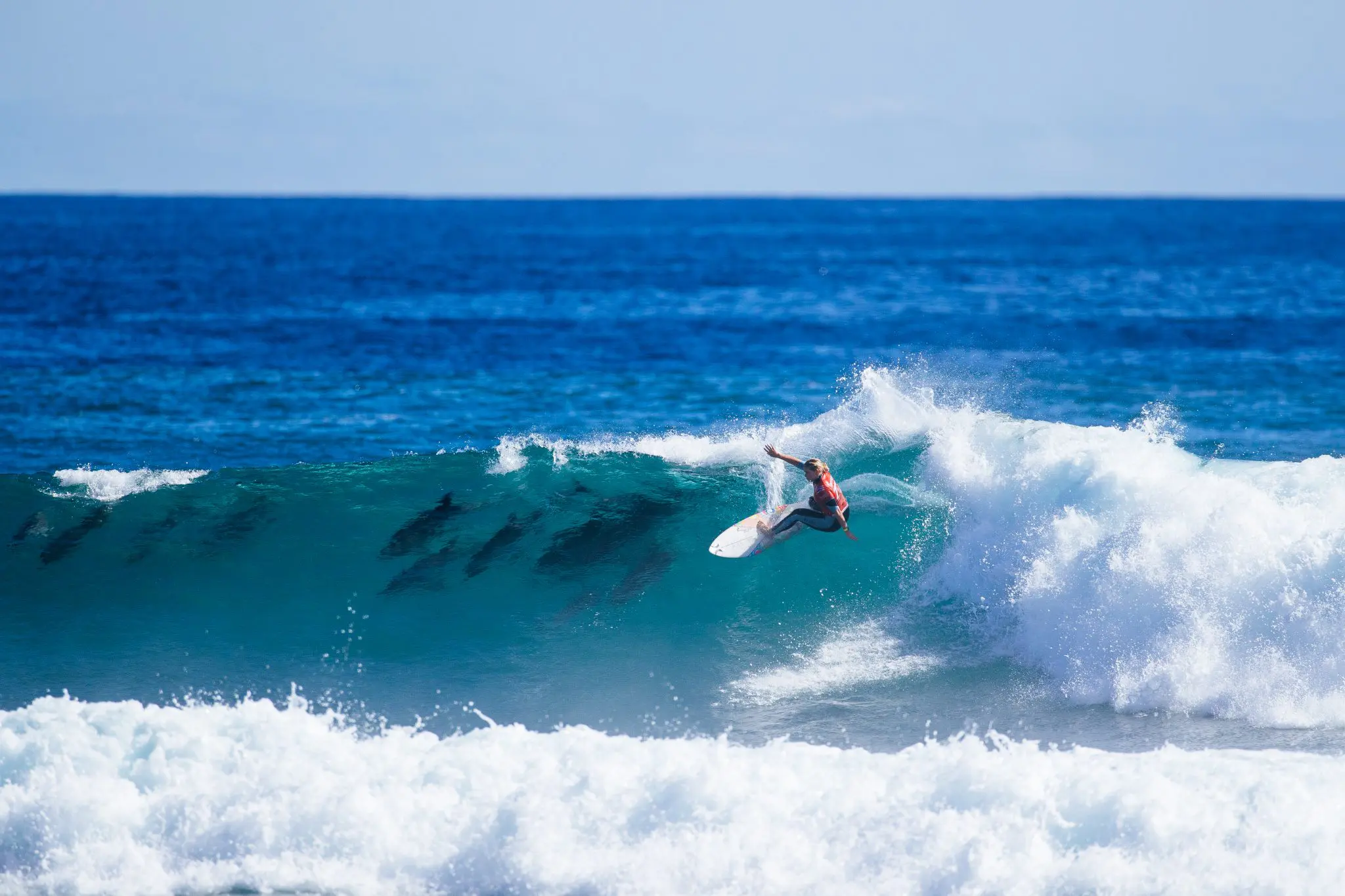 Gabriela Bryan surfing with dolphins in WSL Margaret River Pro